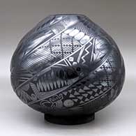 A black on black melon jar carved with eight spiral ribs and each rib decorated with Classic Mimbres animals and geometric designs, click or tap to see a larger version