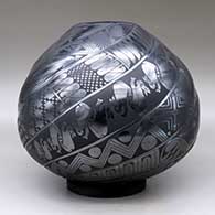 A black on black melon jar carved with eight spiral ribs and each rib decorated with Classic Mimbres animals and geometric designs, click or tap to see a larger version