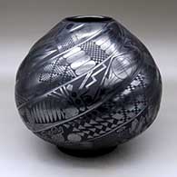 A black on black melon jar carved with eight spiral ribs and each rib decorated with Classic Mimbres animals and geometric designs
 by Macario Ortiz of Mata Ortiz and Casas Grandes