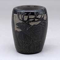 A small black jar decorated with a sgraffito elk and nature design
 by Martin Moquino of Santa Clara