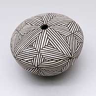 A black-on-white seed pot decorated with a snowflake fine line geometric design
 by Corrine Chino of Acoma