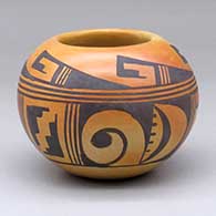 A small polychrome bowl decorated with a band of geometric design around the body
 by Ethel Youvella of Hopi