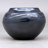 A black on gunmetal black bowl decorated with a four-panel geometric design around the shoulder, click or tap to see a larger version