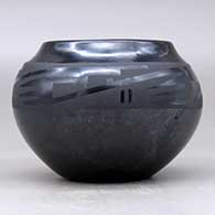 A black on gunmetal black bowl decorated with a four-panel geometric design around the shoulder, click or tap to see a larger version