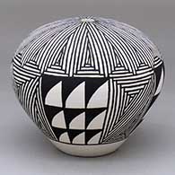 A black-on-white seed pot decorated with a fine line and geometric design
 by Frances Concho of Acoma