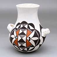 A polychrome water jar with handles and decorated with a four-panel fine line and geometric design
 by Juana Leno of Acoma
