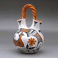 A polychrome wedding vase with a twisted bridge and decorated with a two panel parrot, rainbow, flower, plant and geometric design, click or tap to see a larger version
