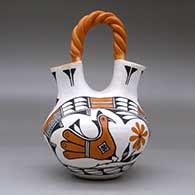 A polychrome wedding vase with a twisted bridge and decorated with a two panel parrot, rainbow, flower, plant and geometric design, click or tap to see a larger version