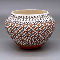 A polychrome jar decorated with a pumpkin seed snowflake and geometric design with a band of Pueblo dancers around the opening
 by Rebecca Lucario of Acoma