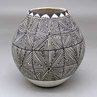 A black-on-white jar decorated with a snowflake fine line and geometric design
 by Mildred Antonio of Acoma