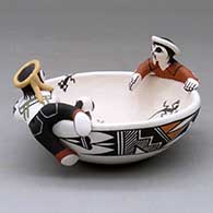 A polychrome friendship bowl with two boys on the rim, a dog, turtle and birds inside and decorated with a fineline and geometric design, click or tap to see a larger version