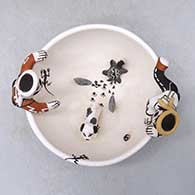 A polychrome friendship bowl with two boys on the rim, a dog, turtle and birds inside and decorated with a fineline and geometric design, click or tap to see a larger version