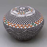 A polychrome seed pot decorated with a checkerboard and geometric design, click or tap to see a larger version