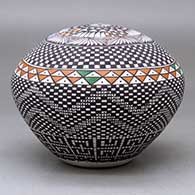 A polychrome seed pot decorated with a checkerboard and geometric design, click or tap to see a larger version