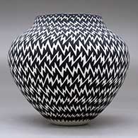 A black on white jar decorated with a lightning bolt geometric design, click or tap to see a larger version