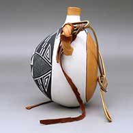 A polychrome flat-back canteen with twisted handles and decorated on the face with a fineline and geometric design, click or tap to see a larger version