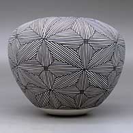A black on white jar decorated around the body with a snowflake fineline geometric design, click or tap to see a larger version