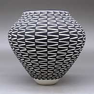 A black on white jar decorated around the body with a geometric design, click or tap to see a larger version