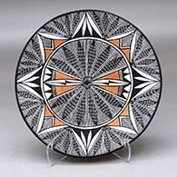 A polychrome plate decorated with a fineline and geometric design
 by Santana Phillips of Acoma
