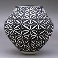 A black on white jar decorated with a yucca-leaf snowflake geometric design, click or tap to see a larger version