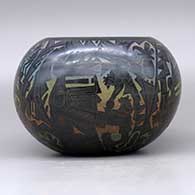 A polychrome bowl decorated with a sgraffito and colored kachina, mudhead, kokopelli, Mimbres insect and animal, and geometric design, click or tap to see a larger version