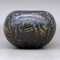 A polychrome bowl decorated with a sgraffito and colored kachina, mudhead, kokopelli, Mimbres insect and animal, and geometric design, click or tap to see a larger version