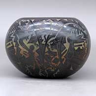 A polychrome bowl decorated with a sgraffito and colored kachina, mudhead, kokopelli, Mimbres insect and animal, and geometric design, click or tap to see a larger version