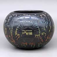 A polychrome bowl decorated with a sgraffito and colored kachina, mudhead, kokopelli, Mimbres insect and animal, and geometric design
 by Ergil Vallo of Acoma