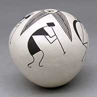 A black on white seed pot with a four panel evolution of kokopelli and fineline design
 by Lucy Lewis of Acoma