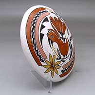A polychrome seed pot decorated above the shoulder with a parrot, branch, leaf, flower and geometric design, click or tap to see a larger version