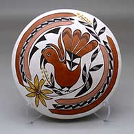 A polychrome seed pot decorated above the shoulder with a parrot, branch, leaf, flower and geometric design
 by Marie S Juanico of Acoma