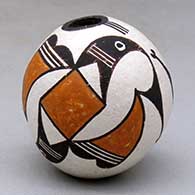 A miniature polychrome seed pot decorated with a two panel bird element and geometric design
 by Lucy Lewis of Acoma