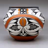 A polychrome jar decorated with a four panel rainbow and geometric design, click or tap to see a larger version