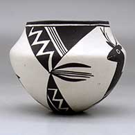 A black on white jar decorated with a four panel deer, lightning bolt and geometric design, click or tap to see a larger version