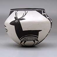A black on white jar decorated with a four panel deer, lightning bolt and geometric design, click or tap to see a larger version