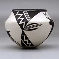 A black on white jar decorated with a four panel deer, lightning bolt and geometric design, click or tap to see a larger version