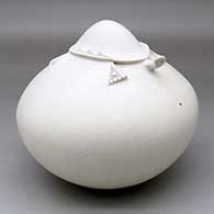 A white seed pot topped with a turtle applique
 by Wilfred Garcia of Acoma
