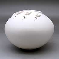A white seed pot decorated with a sculpted bear paw applique, click or tap to see a larger version