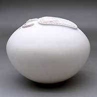 A white seed pot decorated with a sculpted bear paw applique, click or tap to see a larger version