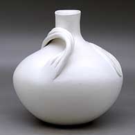 A large white seed pot jar with a short neck, a three strand handle, and a bear paw applique with sgraffito design and cutouts, click or tap to see a larger version