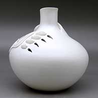 A large white seed pot jar with a short neck, a three strand handle, and a bear paw applique with sgraffito design and cutouts, click or tap to see a larger version