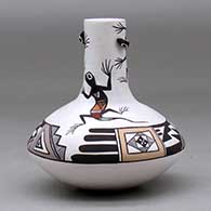 A small polychrome jar with a tall neck and decorated with lizard head appliques and a lizard and geometric design, click or tap to see a larger version