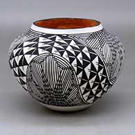 A polychrome jar decorated with a four panel starburst fineline, rainbow and geometric design
 by Marietta Juanico of Acoma