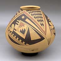 A Ramos Polychrome jar with a flared lip and a three-panel bird element and geometric design
 by Juan Quezada Sr of Mata Ortiz and Casas Grandes