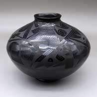 A black-on-black jar with a flared rim and a painted with a four-panel geometric design from the shoulder to the neck
 by Reynalda Quezada of Mata Ortiz and Casas Grandes