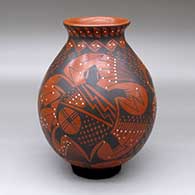 A polychrome jar decorated with a three-panel turtle, lizard, parrot and geometric design
 by Lucy Bugarini of Mata Ortiz and Casas Grandes