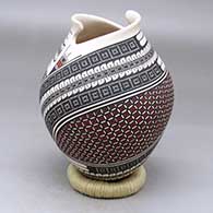 A polychrome jar with a geometric cut opening and a geometric design around the body
 by Mirna Hernandez of Mata Ortiz and Casas Grandes