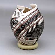 A polychrome jar with a geometric cut opening and a geometric design around the body
 by Mirna Hernandez of Mata Ortiz and Casas Grandes