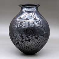 A black on black jar with a rolled lip and a two-panel medallion, bird, spiral and geometric design, click or tap to see a larger version