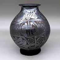 A black on black jar with a rolled lip and a two-panel medallion, bird, spiral and geometric design, click or tap to see a larger version